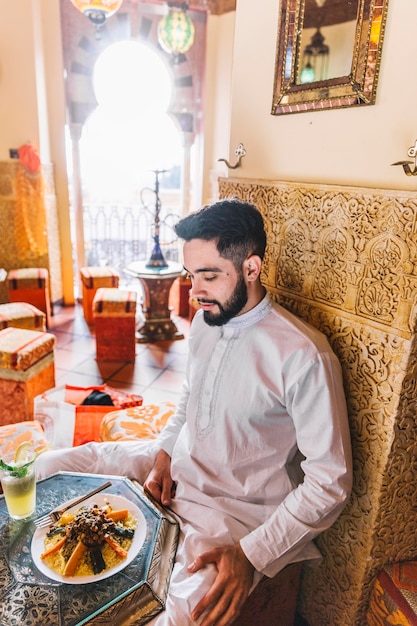 Free Photo muslim man sitting in restaurant