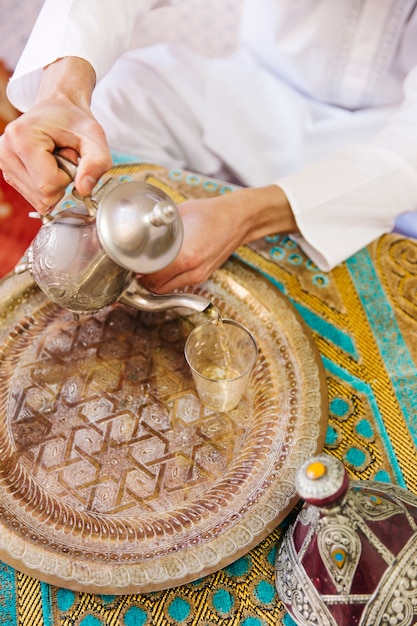 Free Photo muslim man sitting on table with tea