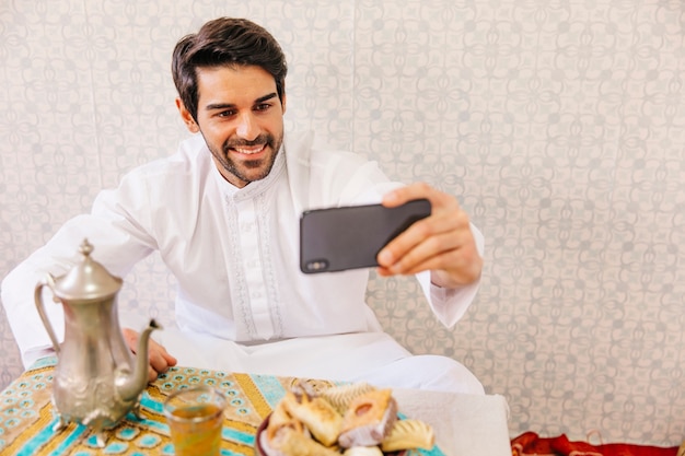 Free photo muslim man taking selfie