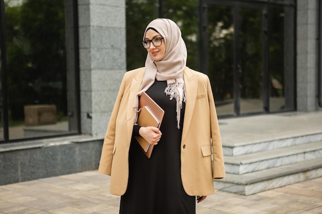 Muslim woman in hijab in city street