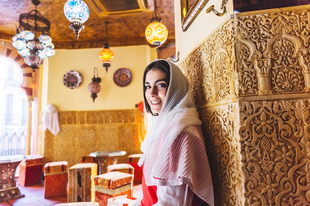 Muslim woman leaning against wall