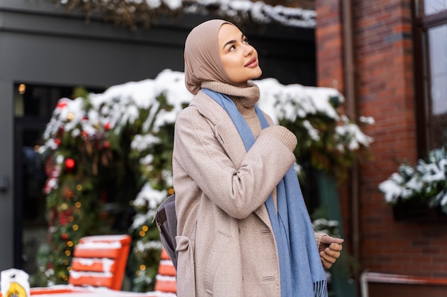 Muslim woman looking at the architecture of the buildings while traveling