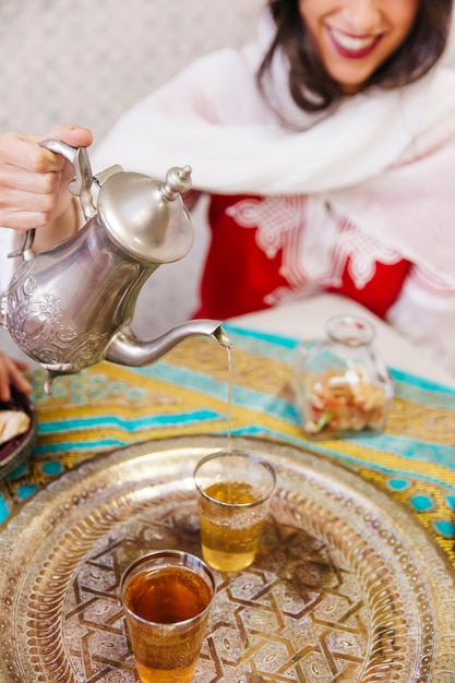 Muslim woman pouring tea