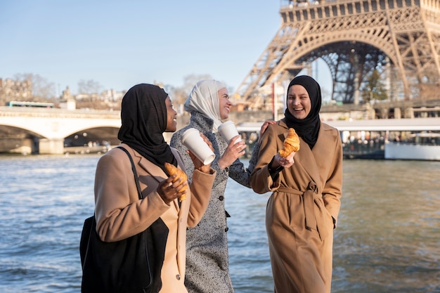 Free photo muslim women traveling in paris together