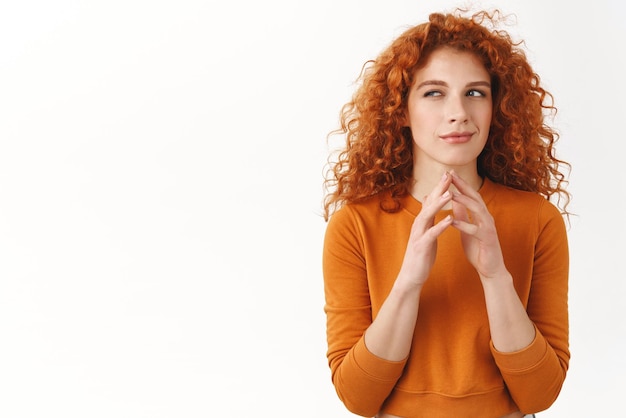 My evil plan is perfect Hideous gorgeous redhead female scheming something steeple fingers squinting cunning and smirk madeup good idea thinking pondering choices stand white background