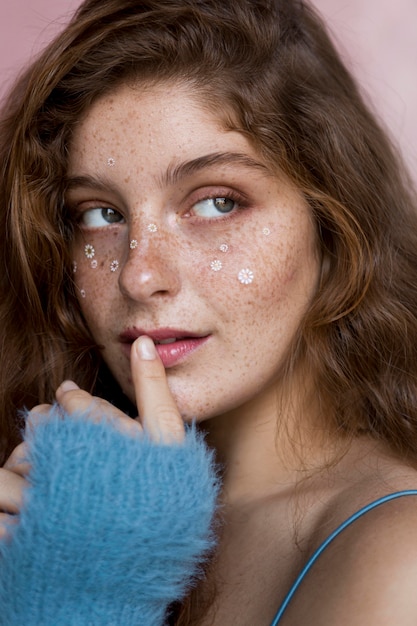 Free Photo mysterious freckled woman with white flowers on her face