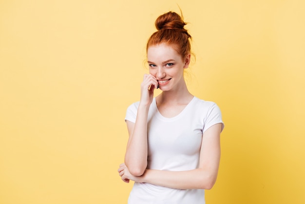 Mystery ginger woman in t-shirt bites her finger