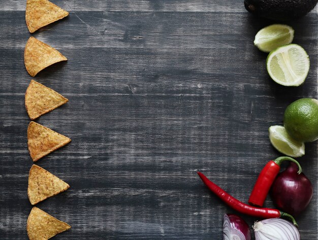 Nachos with lime and onion on the table