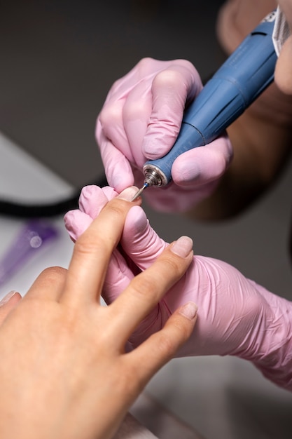 Nail art professional working on client nails