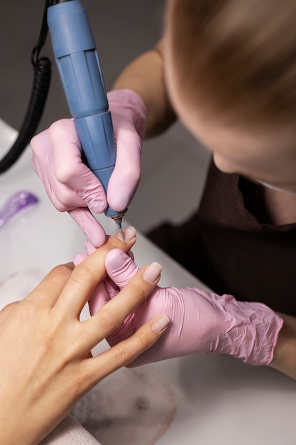 Nail art professional working on client nails