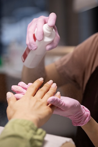 Nail art professional working on client nails