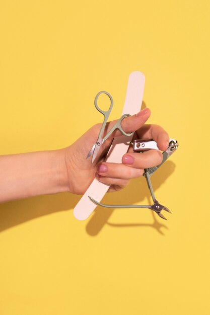 Nail art with hand holding scissors