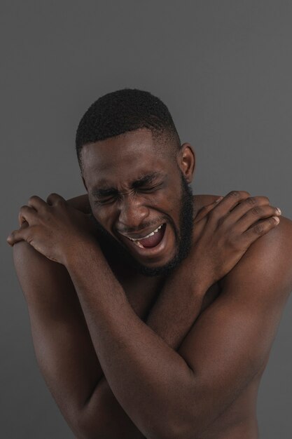 Naked man screaming and looking down