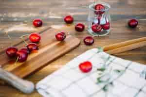 Free photo napkin near juicy ripe cherries on cutting board