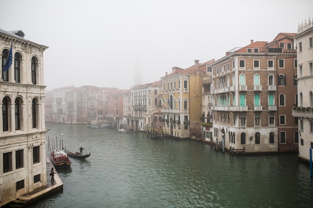 Free Photo narrow canal among old colorful brick houses in venice, italy.