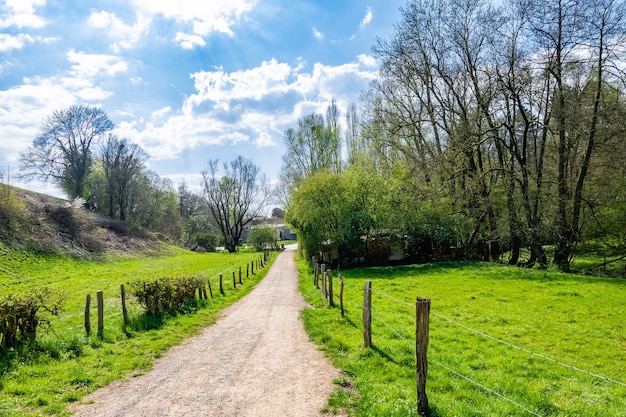 Narrow path in the countryside surrounded by green valley