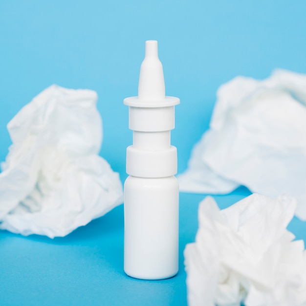 Free photo nasal spray bottle and tissues