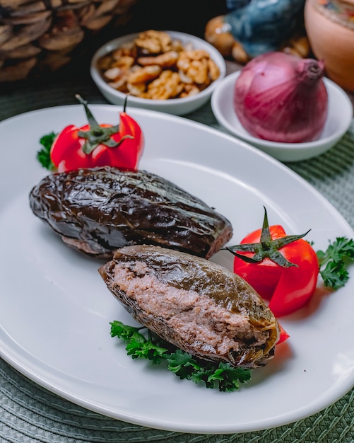 Free Photo national dish eggplant dolma meat tomato parsley side view