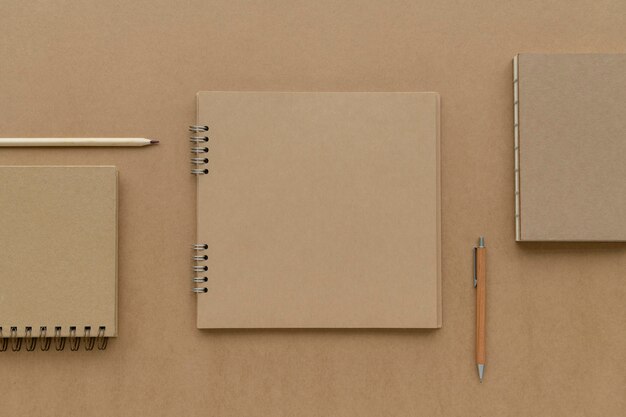 Natural brown paper notebook with pencils mockup