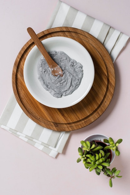 Natural facial mask on rounded wooden board