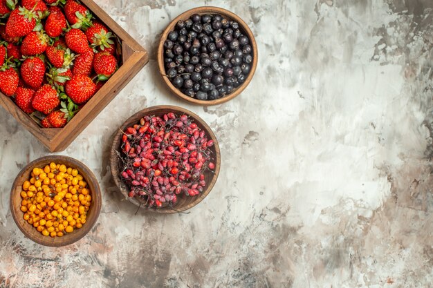 Natural and fresh various fruits in small brown wooden pots