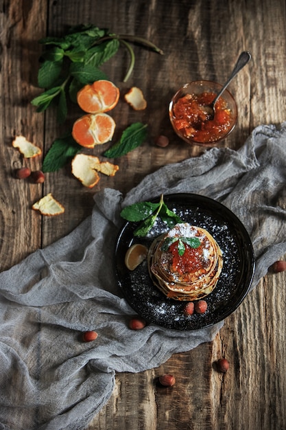 Free photo natural mandarin jam on wooden table