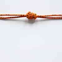 Free photo nautical orange rope knot with shadows