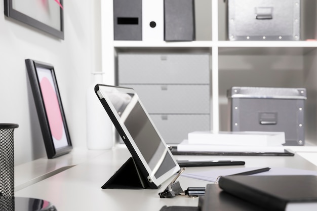 Free photo neat and tidy workspace with tablet on desk