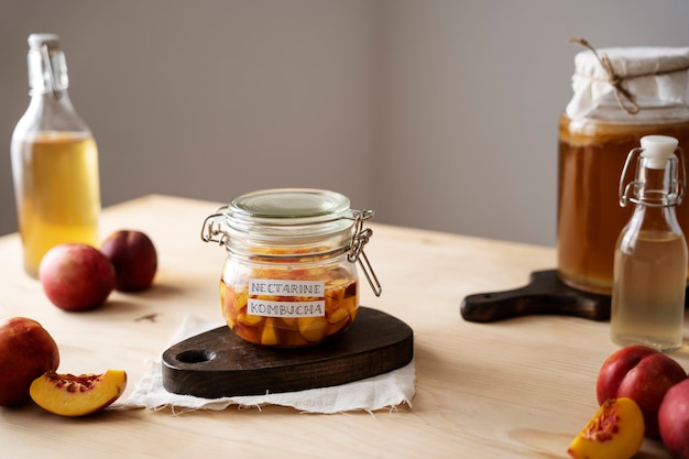 Free photo nectarine kombucha jar with label on table