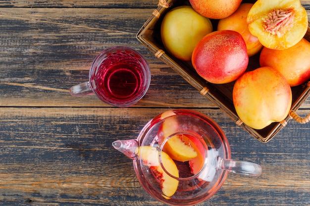 Free Photo nectarines in a basket with cold drink top view on a wooden table