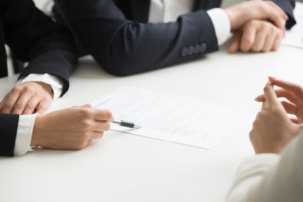 Negotiations about contract terms concept, hand pointing at document, closeup 