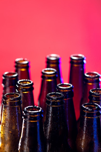 Free photo neon colored beer bottles. close up on bright