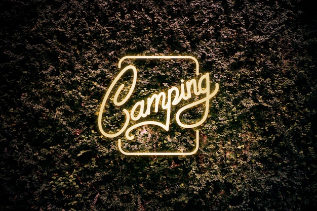 Free Photo neon yellow camping sign on a leaves