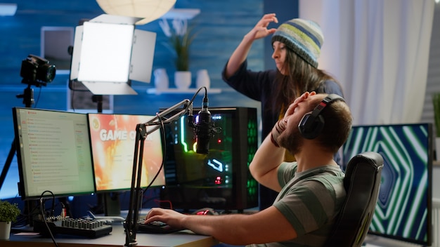 Free Photo nervous players couple losing online videogames competition using powerful computer screaming at each other. streamer gamer playing video games with rgb keyboard performing at gaming turnament