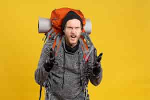 Free photo nervous young man with leather gloves and backpack