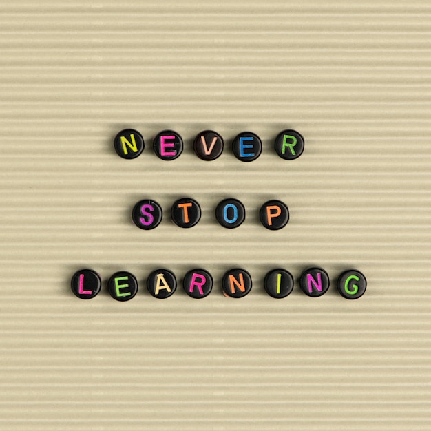 Free Photo never stop learning  beads message typography