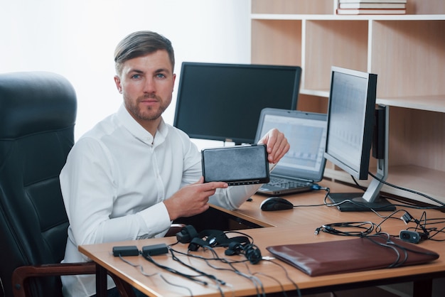 New equipment. Polygraph examiner works in the office with his lie detector