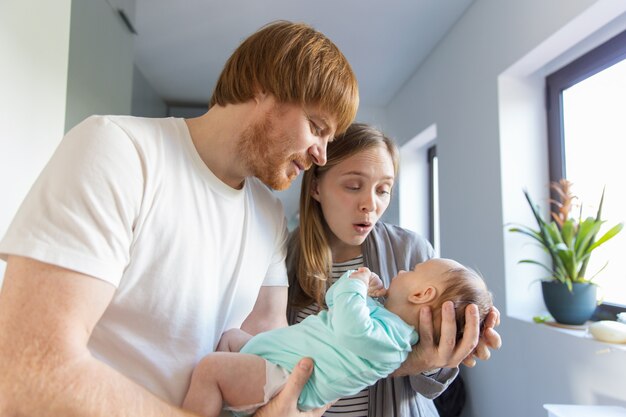 New mother and father communicating with baby