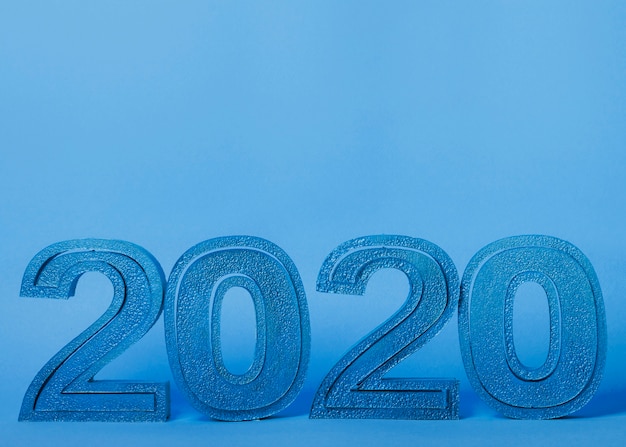 Free Photo new year 2020 numbers on blue background with copy space