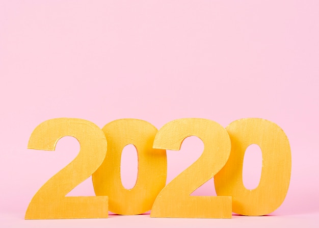 Free Photo new year 2020 numbers on pink background with copy space