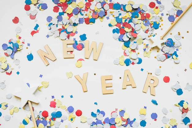 Free photo new year background with colorful confetti and letters