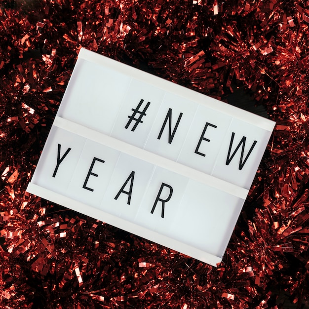 Free photo new year celebration text with red tinsel