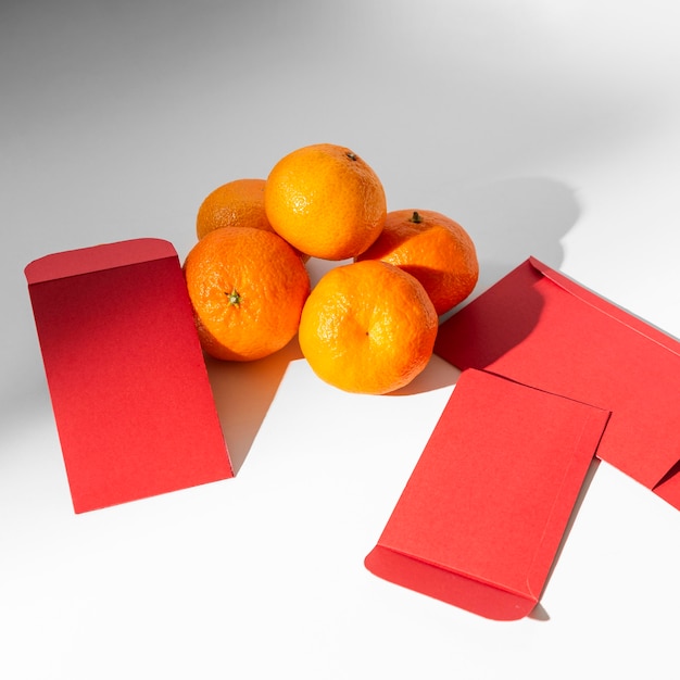 Free photo new year chinese 2021 oranges and envelopes