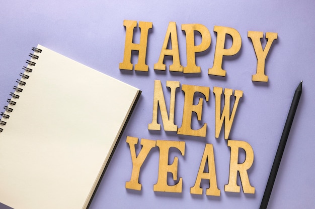 Free photo new year composition with letters and notebook