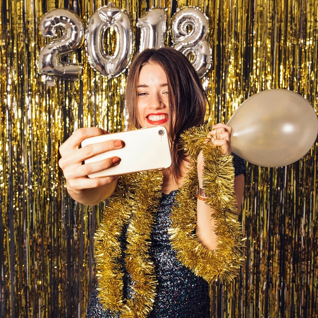 New year concept with joyful girl taking selfie