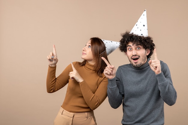 New year concept with lovely excited happy young couple wear new year hat on gray image