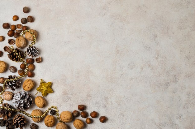 New year decorations beside nuts and chestnuts on table