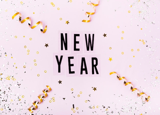 Free photo new year lettering  with ribbon