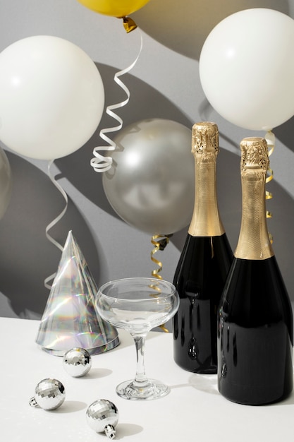 Free photo new year party arrangement with champagne bottle