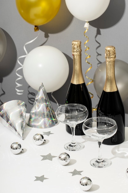 Free photo new year party arrangement with champagne bottle